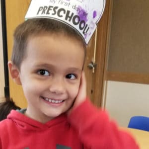 Cute boy with hat at preschool